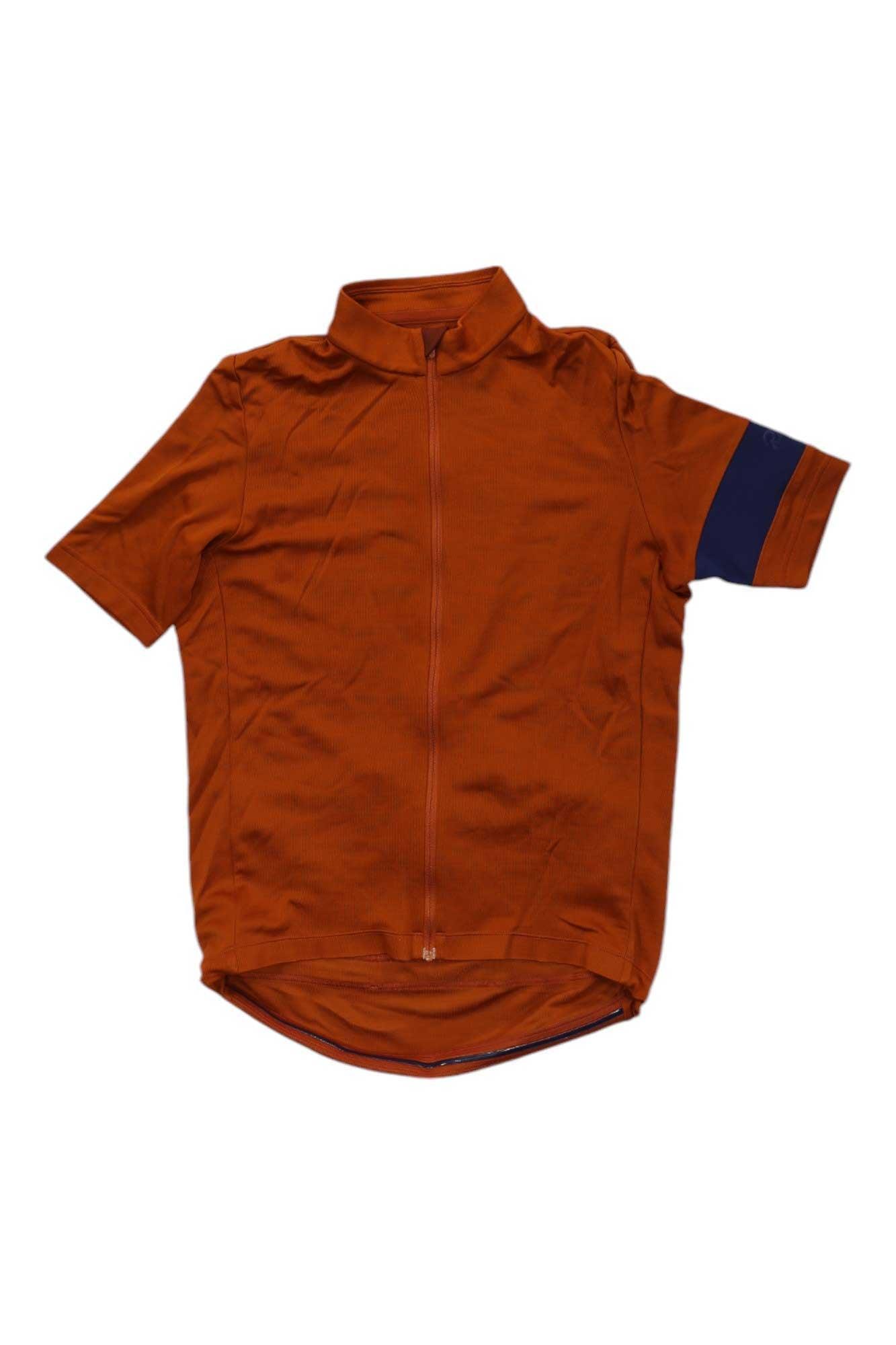 The Rapha Mens Classic Jersey in short sleeves features a burnt orange color, full front zipper, and a navy blue band on the left sleeve—an essential cycling top combining style and performance.