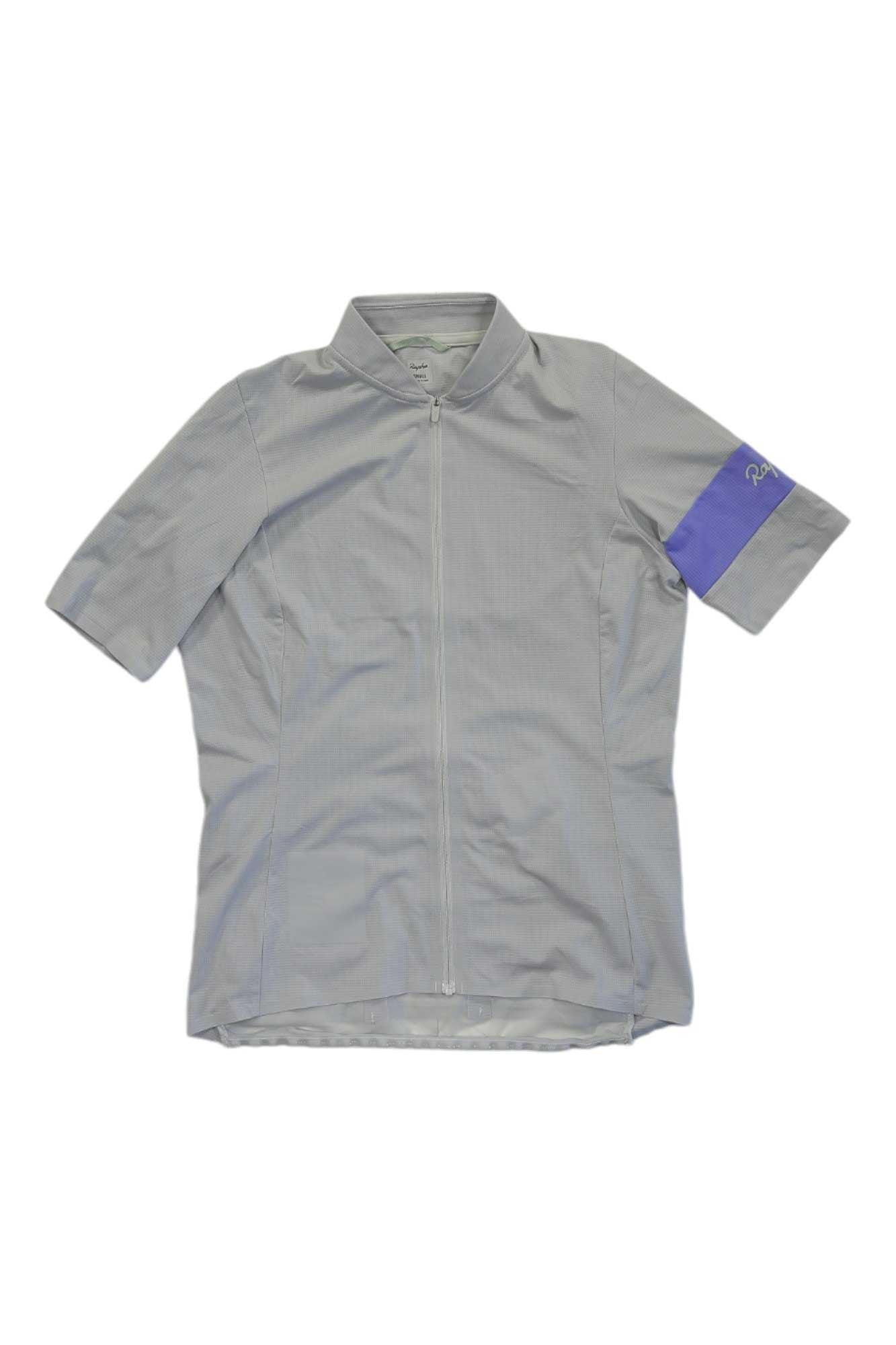 A gray Rapha Womens Classic Flyweight Jersey with short sleeves, front zipper, and a purple band on the left sleeve is laid flat on a white background.
