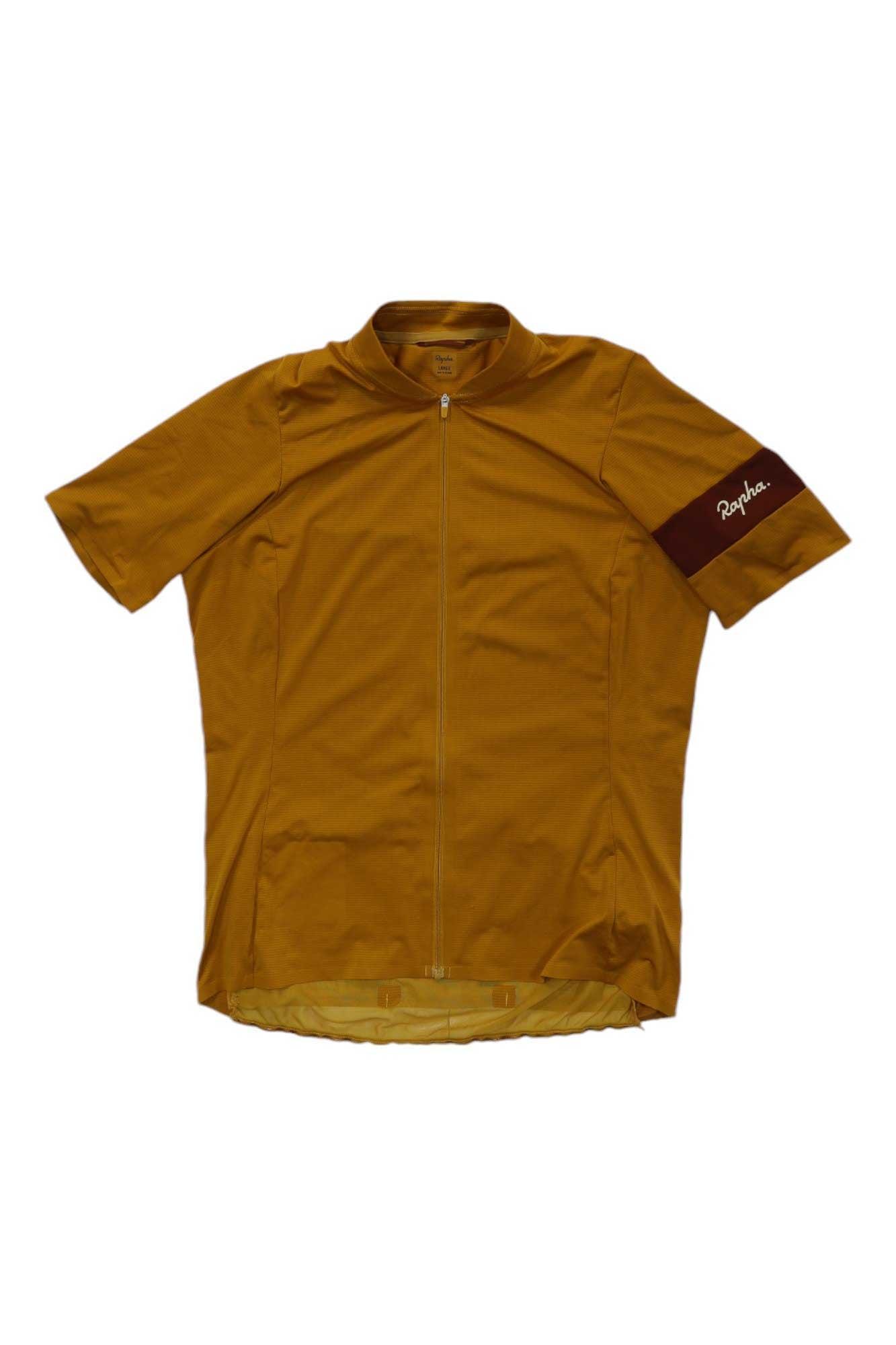 The Rapha Womens Classic Flyweight Jersey is a lightweight, short-sleeve cycling jersey in mustard yellow with a full front zipper and a maroon left sleeve band featuring the white Rapha logo—ideal for warm weather rides.