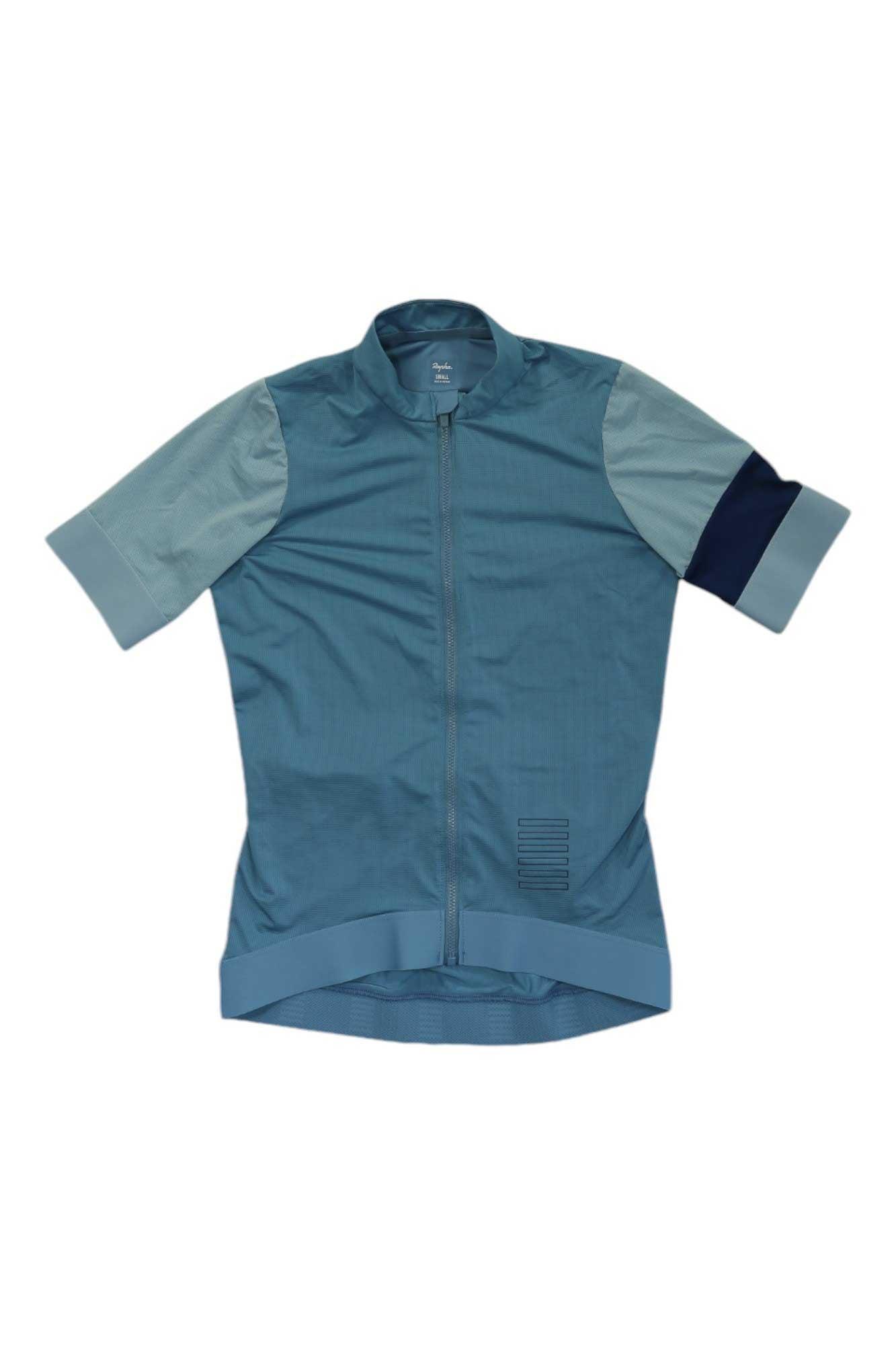 The Rapha Women's Pro Team Training Jersey is a short-sleeve, eco-friendly cycling jersey in blue with color-blocked sleeves, zip front, and ribbed details—ideal for pro team training rides.