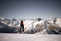 A snowboarder looking at a mountain