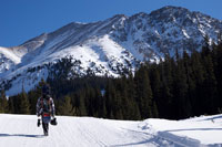 snowboarder walking on mountain trail