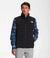 A man wears a black The North Face Men’s Belleview Stretch Down Vest over a blue plaid shirt, standing against a white background with his hands in his pockets and looking slightly to the side.