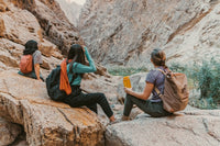 Group of hikers taking a break on rocks