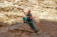 woman climbing a rock face