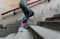 woman in leggings climbing concrete stairs