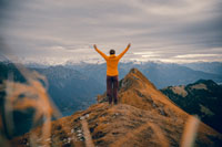 A woman standing on top of a mountain