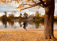 woman running on a trail in the fall