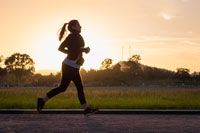 woman running on the side of a road