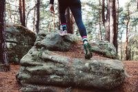 woman wearing sneakers on a rock