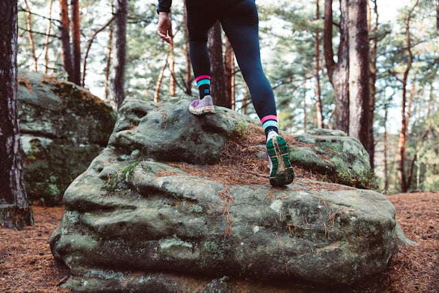 woman wearing sneakers on a rock