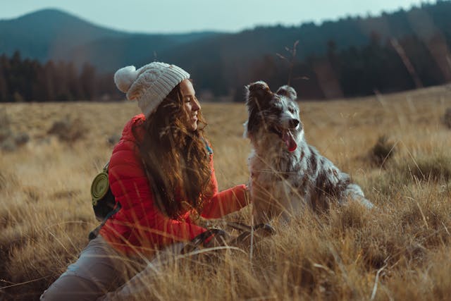 woman sitting outside with a dog