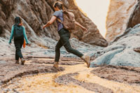 women walking in the dirt surrounded by rocks