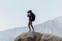 woman taking a photo on a mountain