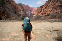 woman hiking to a canyon