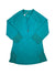 The Brigitte Sun Top is a teal stretch tricot rashguard tunic with a front zipper and mesh details on the lower sleeves and sides, shown on a flat white background.