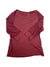The Womens Flash Dry Long Sleeve Shirt, featuring a scoop neck and maroon color, made from recycled material, is displayed laid flat on a white background with one sleeve crossed over the front.