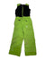 The Mini Expedition Pant is bright green with black adjustable shoulder straps, a front zipper, PrimaLoft Black Eco insulation, reinforced knees, and a Spyder logo on the left thigh. Shown on a white background.
