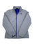 A light gray Womens Bombay Jacket by The North Face with a blue zipper and logo, stand-up collar, and long sleeves is laid flat on a white background; this lightweight insulated jacket is ideal for layering.