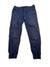 Womens Notion Pant in navy blue, featuring 4-way stretch fabric, elastic waistband with drawstring, side pockets, visible knee stitching, and elastic ankle cuffs—ideal for climbing. Shown laid flat on a white background.