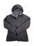 The Women's Burton Jet Set Jacket in dark gray features synthetic insulation, a subtle plaid pattern, front buttons, and side pockets, shown against a white background.