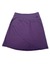 The Womens Better Butter Skirt is a purple, knee-length wrap-style skirt made from stretch fabric, featuring a small logo near the waistband and displayed on a white background.