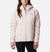 A person stands facing forward against a plain white background, wearing a light pink Columbia Women's Kruser Ridge II Softshell Jacket and black pants, highlighting stylish outdoor activewear.