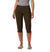 A person in a gray top, white flip-flops, and Women's Anytime Casual Capri Pants—dark brown, knee-length, and designed for travel and sun protection—stands against a plain white background.